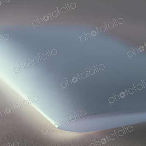 A folded piece of white recycled paper, close up. A folded piece of white recycled paper, close up.