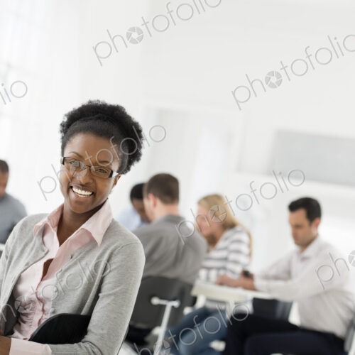 A fresh white building interior, flooded with light. A group of people meeting. One… A fresh white building interior, flooded with light. A group of people meeting. One…
