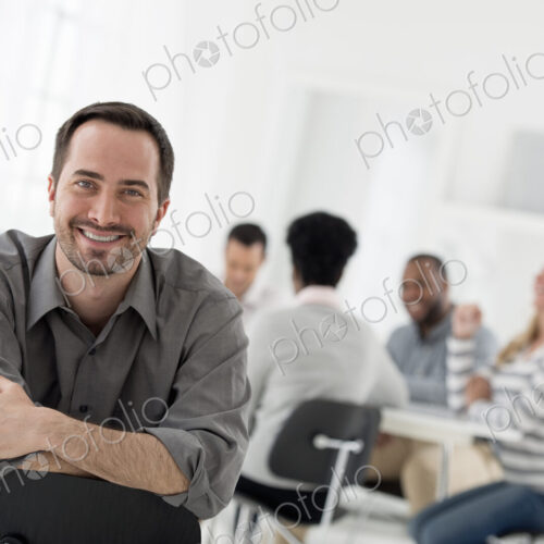 A fresh white building interior, flooded with light. A man seated with his armed… A fresh white building interior, flooded with light. A man seated with his armed…