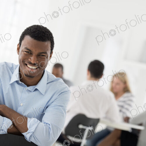 A fresh white building interior, flooded with light. A man seated with his armed… A fresh white building interior, flooded with light. A man seated with his armed…