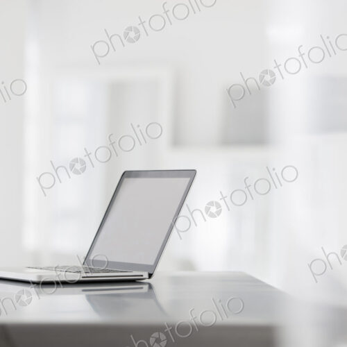 A fresh white building interior, flooded with light. A smooth shiny grey tabletop, and… A fresh white building interior, flooded with light. A smooth shiny grey tabletop, and…