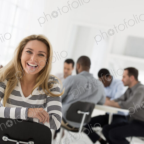 A fresh white building interior, flooded with light. A woman in a striped shirt seated… A fresh white building interior, flooded with light. A woman in a striped shirt seated…