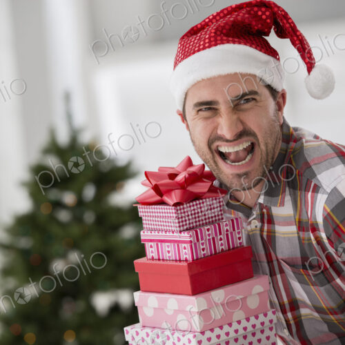 A fresh white building interior, flooded with light. Celebrating Christmas. A man in a… A fresh white building interior, flooded with light. Celebrating Christmas. A man in a…