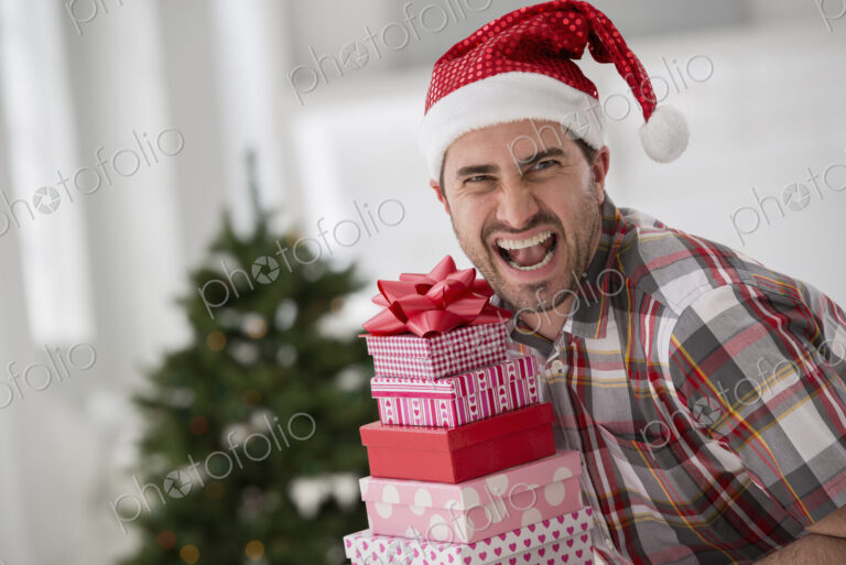 A fresh white building interior, flooded with light. Celebrating Christmas. A man in a…
