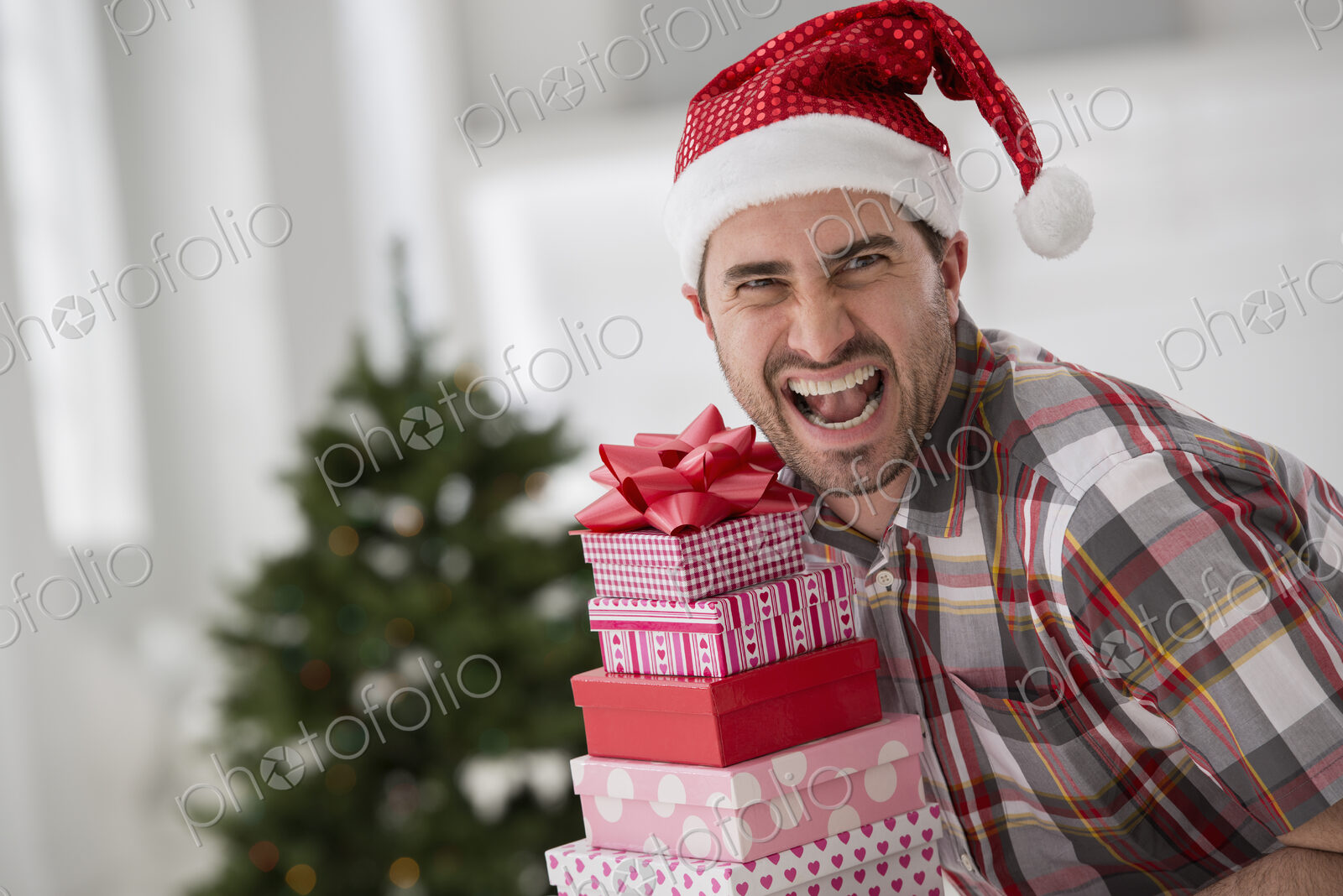 A fresh white building interior, flooded with light. Celebrating Christmas. A man in a…
