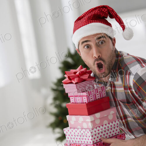 A fresh white building interior, flooded with light. Celebrating Christmas. A man in a… A fresh white building interior, flooded with light. Celebrating Christmas. A man in a…