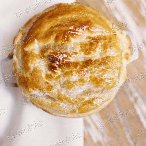 A freshly baked pie with a pastry top on a table A freshly baked pie with a pastry top on a table