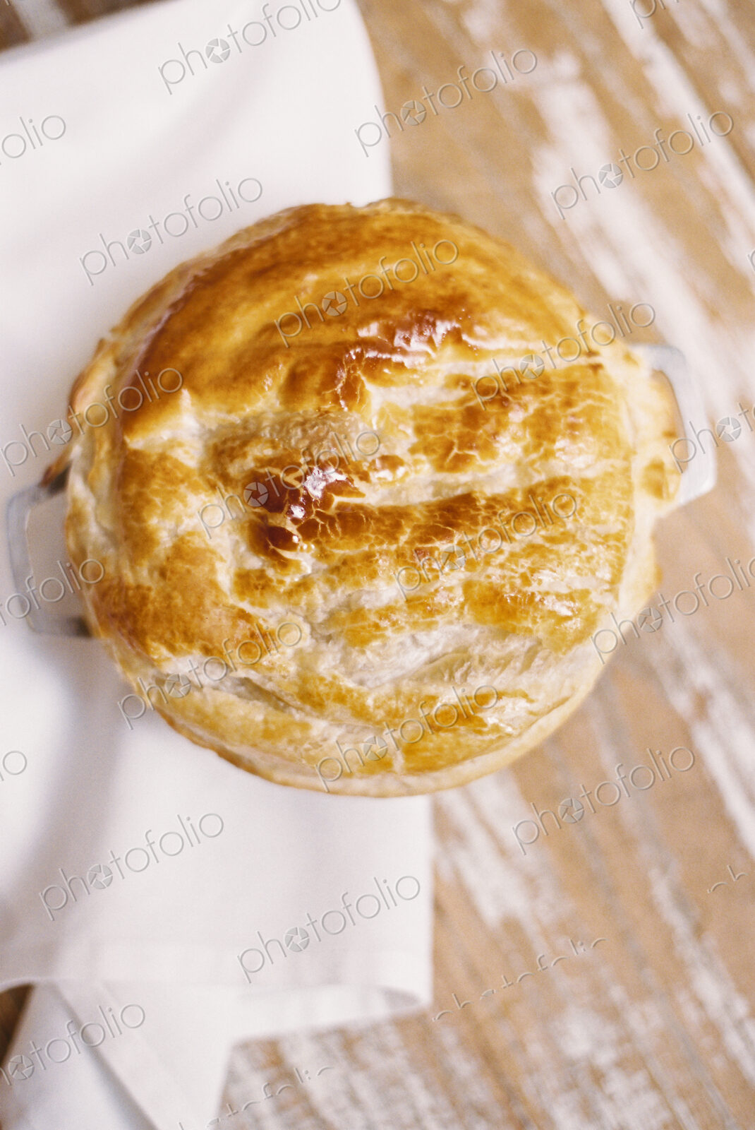 A freshly baked pie with a pastry top on a table