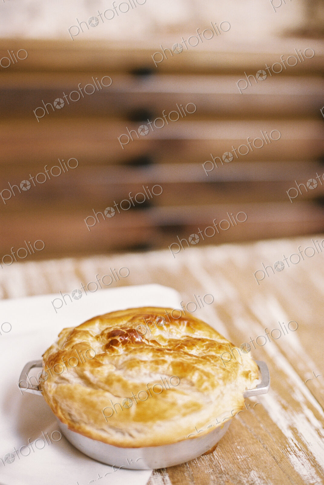A freshly baked pie with a pastry top on a table