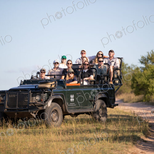 A game drive vehicle, full of people on safari. A game drive vehicle, full of people on safari.