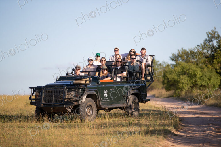 A game drive vehicle, full of people on safari.