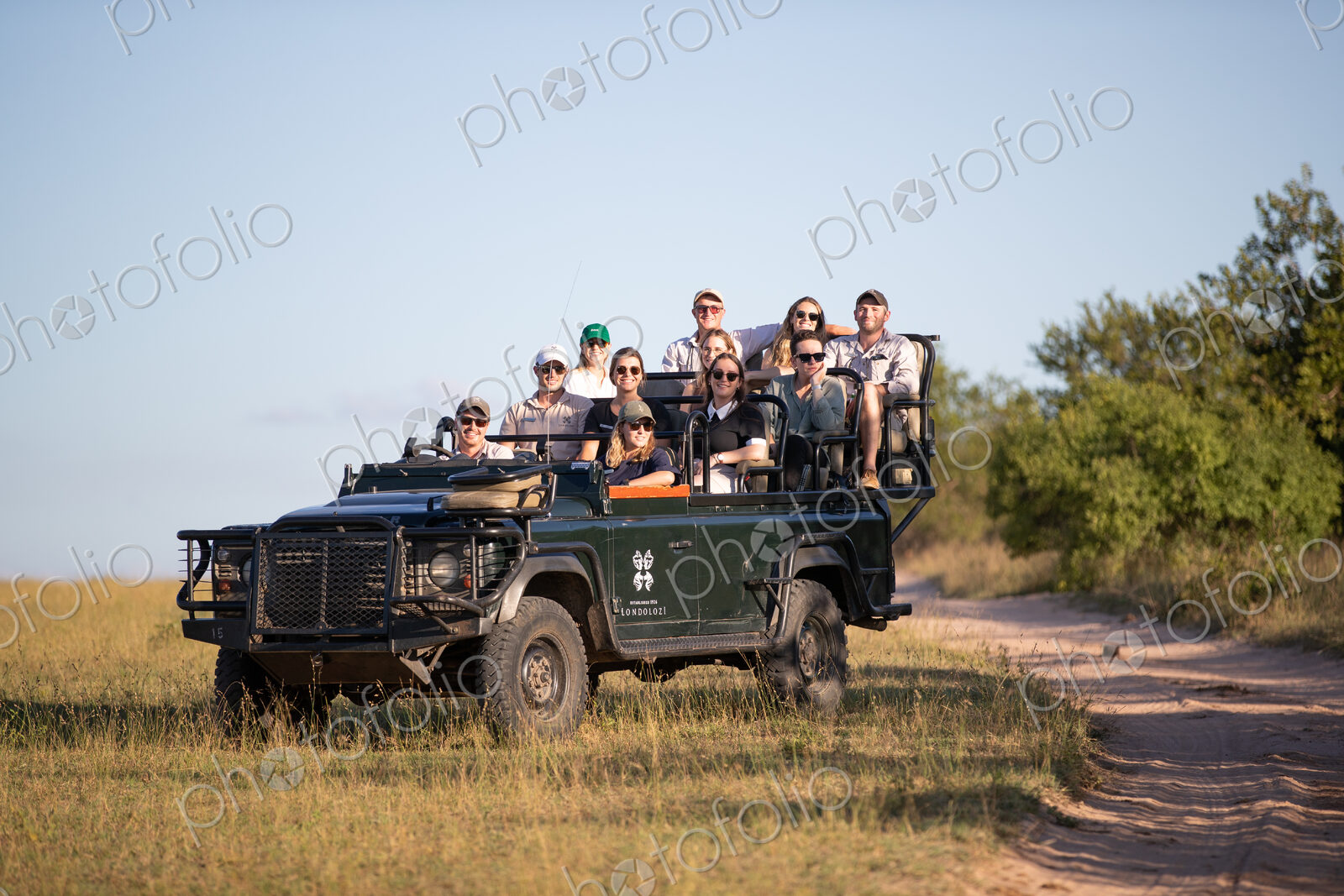 A game drive vehicle, full of people on safari.
