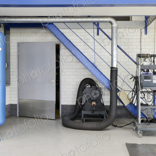 A garage or auto repair shop air pressure valve with compressor machine