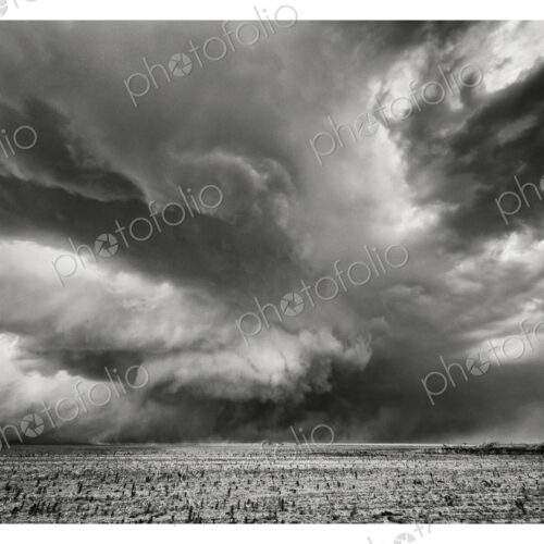 A gathering storm, threatening skies, shapes in the air, black and white image. A gathering storm, threatening skies, shapes in the air, black and white image.