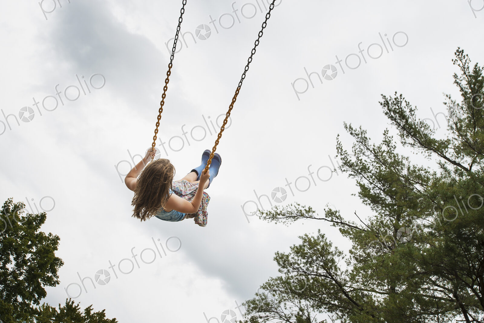 A girl on a rope swing, high in the air