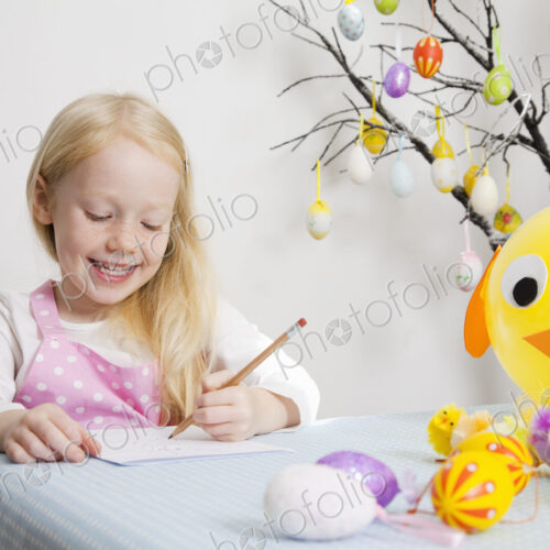 A girl sitting at a table drawing. A girl sitting at a table drawing.