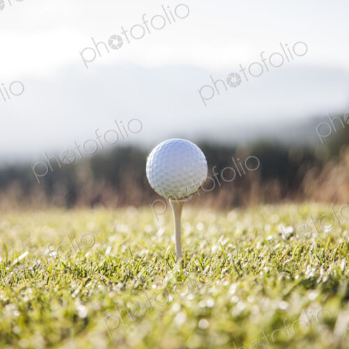 A golf ball on a tee ready to be hit. A golf ball on a tee ready to be hit.