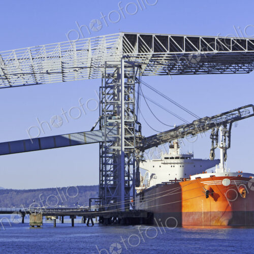 A grain container ship being loaded at the docks in Port of Tacoma. Washington State.