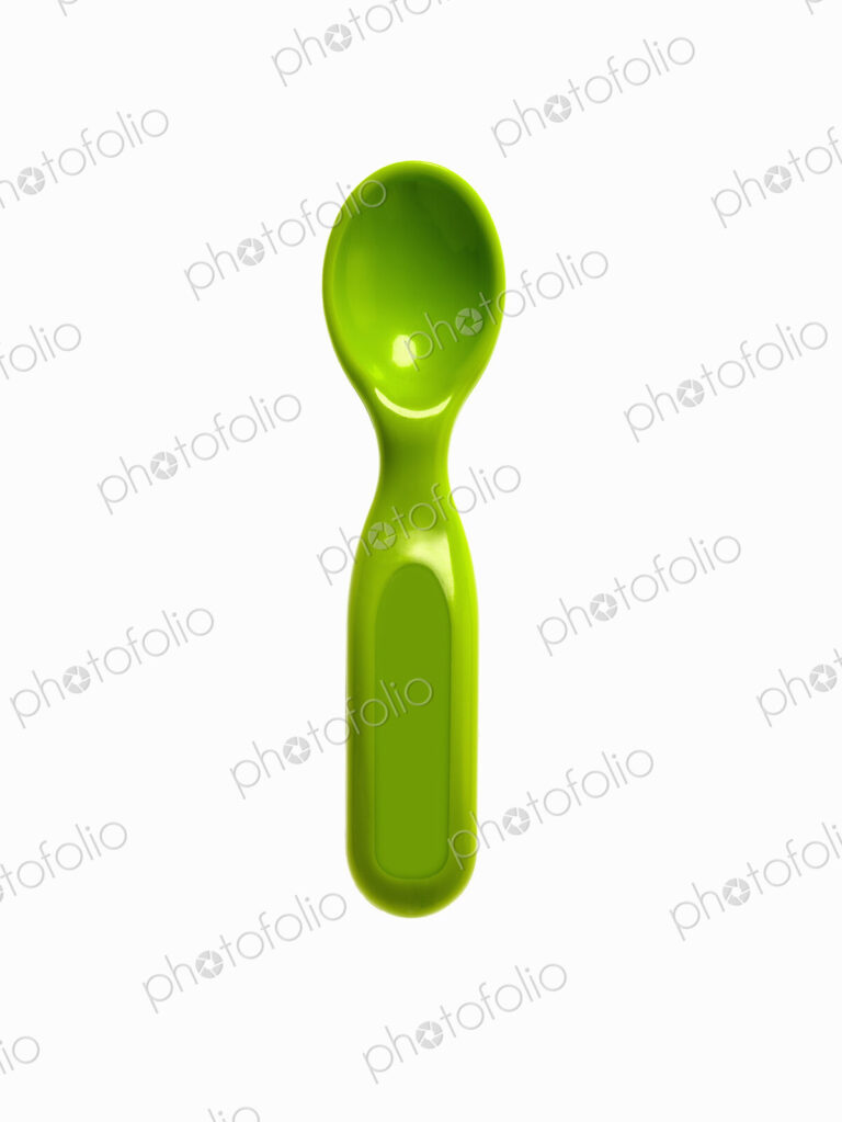 A green plastic baby spoon.