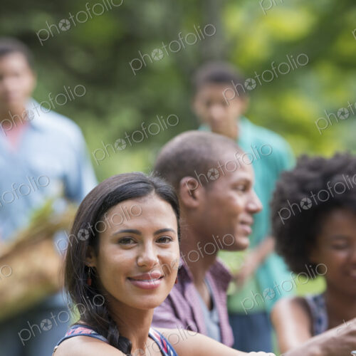 A group of adults and young people at a meal in the garden of a farmhouse. A group of adults and young people at a meal in the garden of a farmhouse.