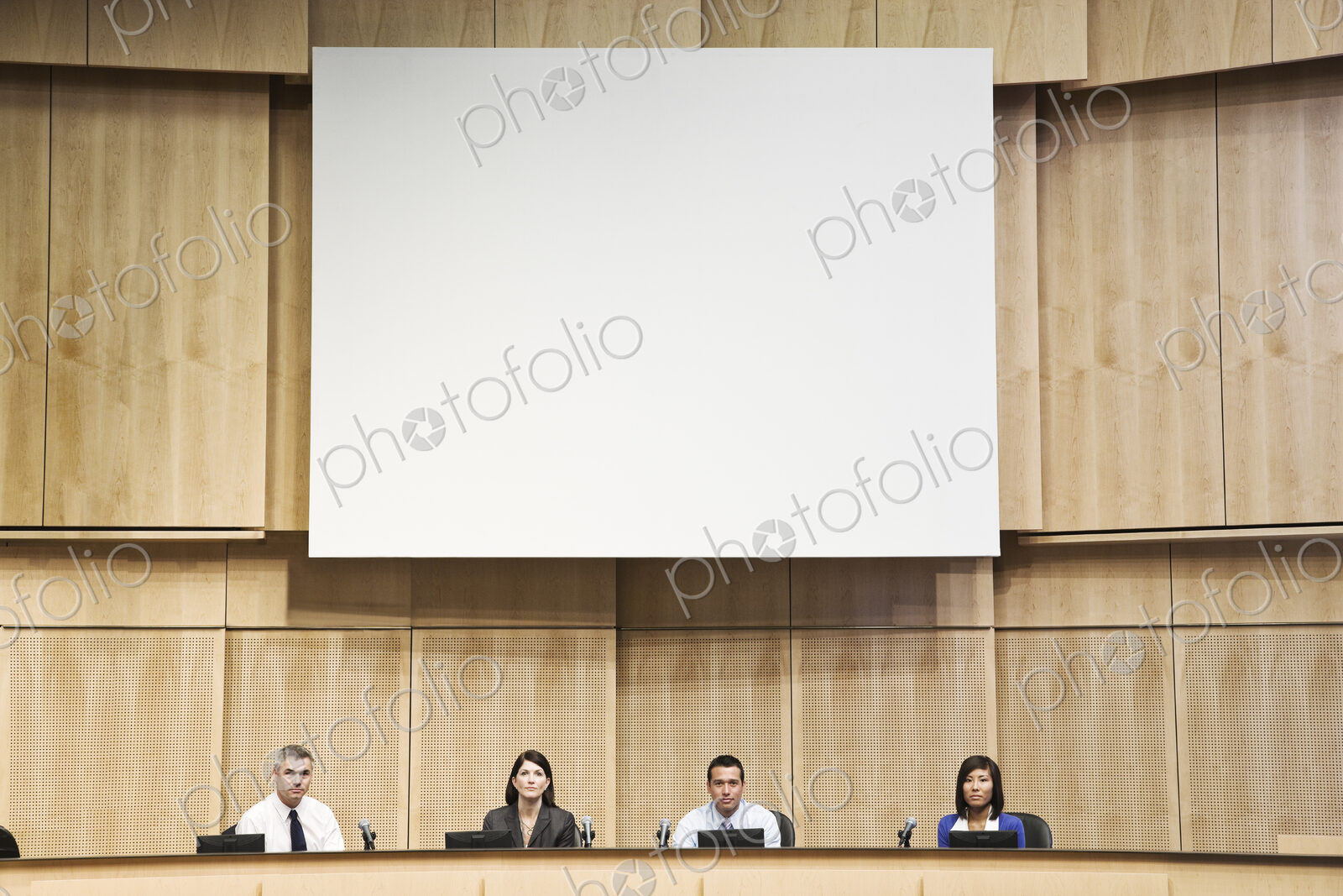 A group of businesswomen and men in a poltical meeting.