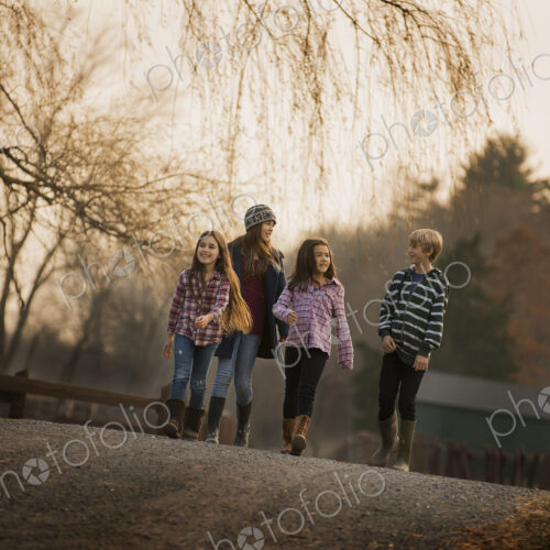 A group of children, a boy and four girls, walking along a path, on a winter's day. An… A group of children, a boy and four girls, walking along a path, on a winter's day. An…