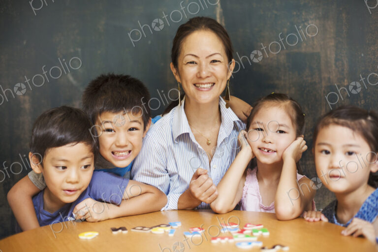 A group of children, boys and girls in a classroom with their teacher.