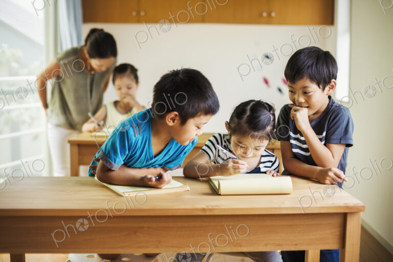 A group of children in a classroom with their female teacher.
