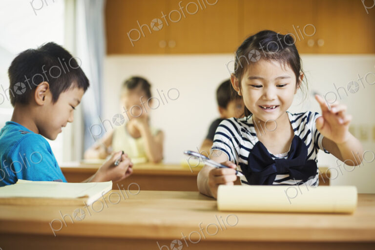 A group of children in a classroom, working together, boys and girls.