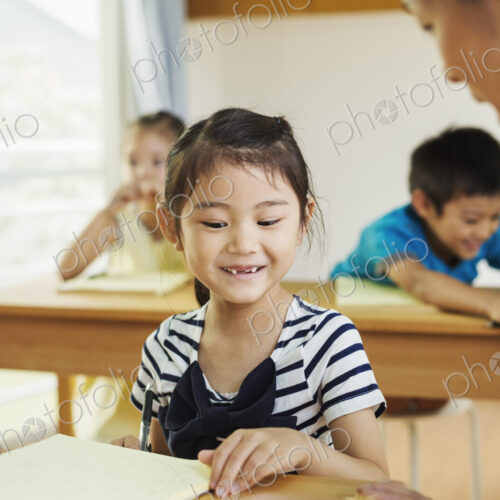 A group of children in a school classroom with their teacher.