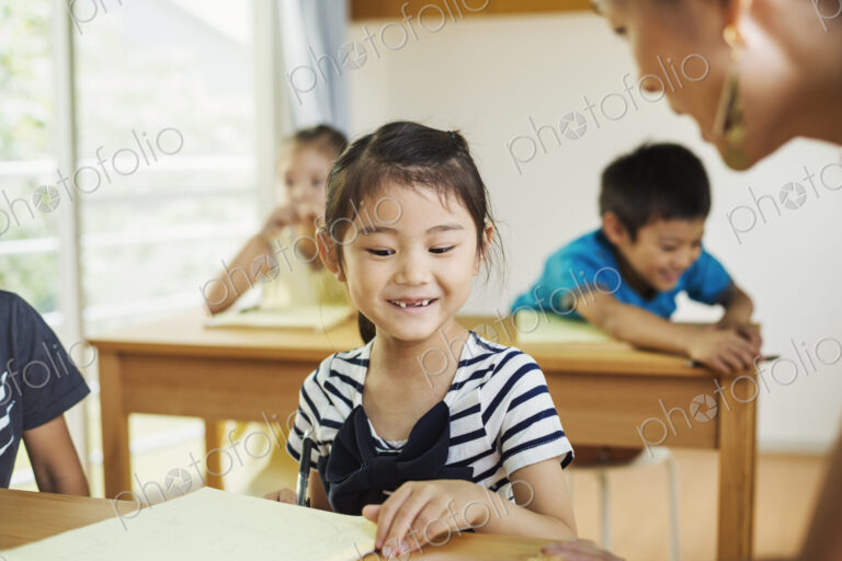 A group of children in a school classroom with their teacher.