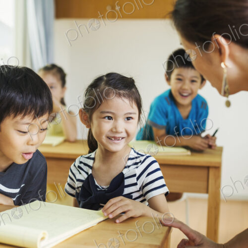 A group of children in a school classroom with their teacher.