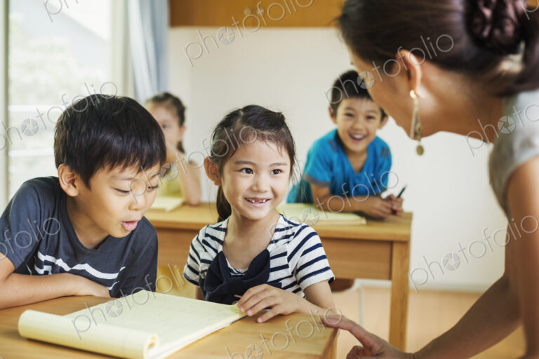 A group of children in a school classroom with their teacher.