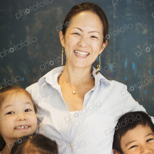 A group of children in school with a teacher. A group of children in school with a teacher.