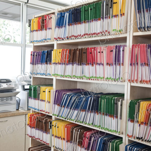 A group of colorful file folders in a dental office. A group of colorful file folders in a dental office.