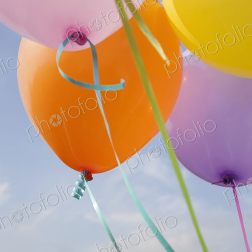 A group of coloured balloons floating in the air. A group of coloured balloons floating in the air.