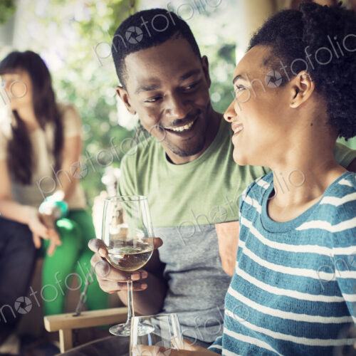 A group of friends, men and women at a house party, a couple side by side.