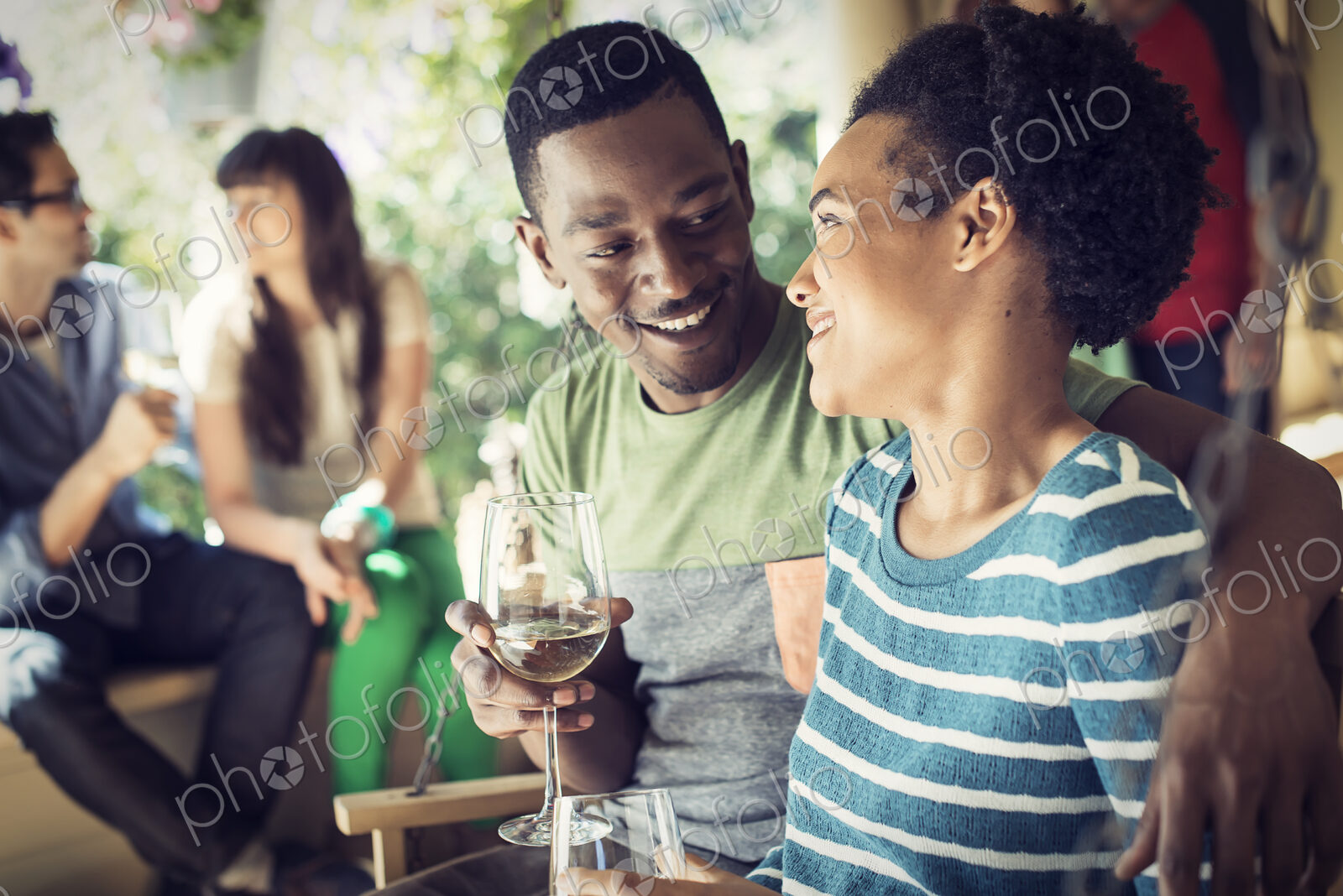 A group of friends, men and women at a house party, a couple side by side.