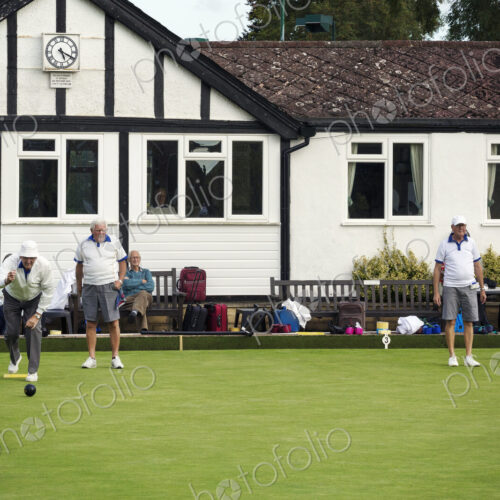 A group of lawns bowls players by a clubhouse, preparing for play. A group of lawns bowls players by a clubhouse, preparing for play.