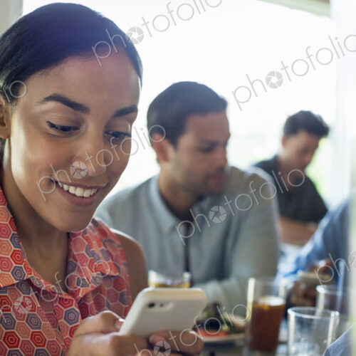 A group of men and women in a cafe, having drinks and enjoying each other's company. A group of men and women in a cafe, having drinks and enjoying each other's company.