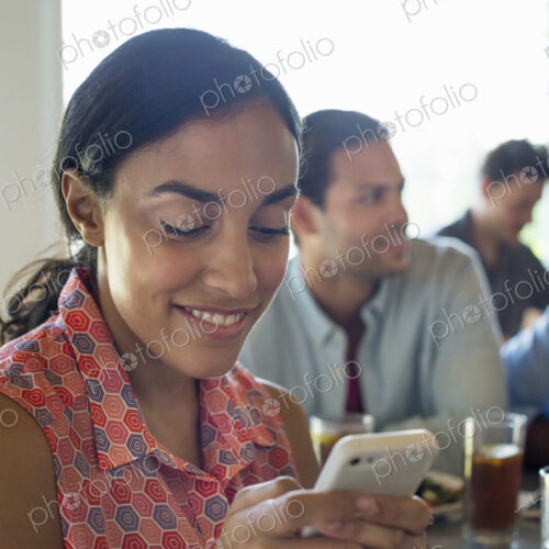 A group of men and women in a cafe, having drinks and enjoying each other's company. A group of men and women in a cafe, having drinks and enjoying each other's company.