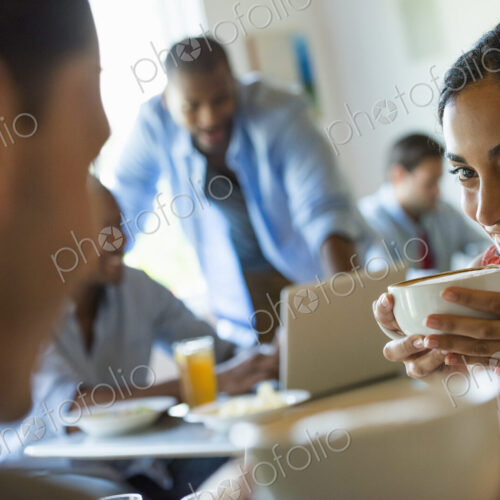 A group of men and women in a cafe, having drinks and enjoying each other's company. A group of men and women in a cafe, having drinks and enjoying each other's company.