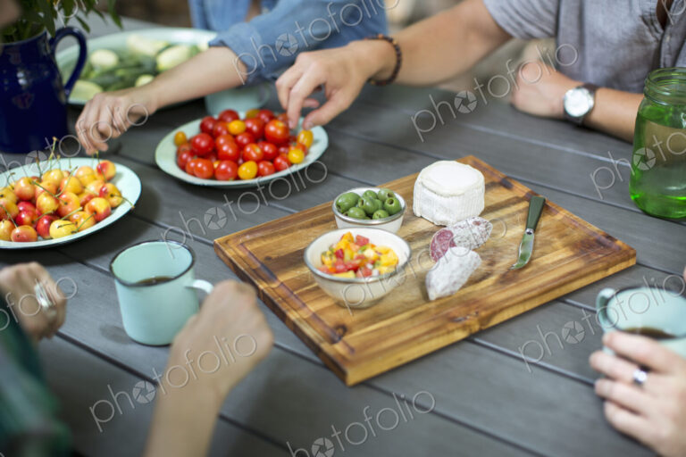 A group of people gathered around a table with a buffet laid out