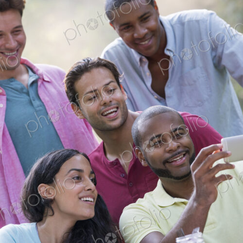 A group of people having a meal outdoors, a picnic. Men and women. A group of people having a meal outdoors, a picnic. Men and women.