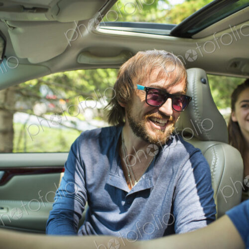 A group of people inside a car, on a road trip. A driver and two passengers. A group of people inside a car, on a road trip. A driver and two passengers.