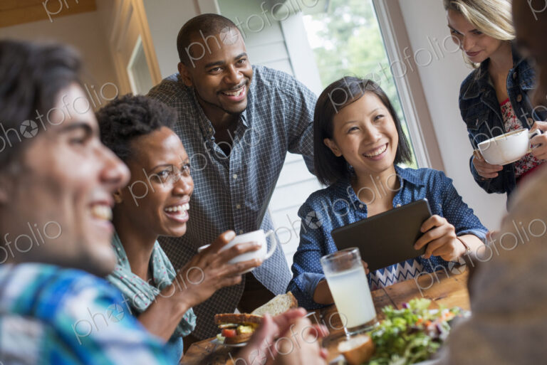 A group of people meeting in a cafe. Using digital tablets and smart phones.