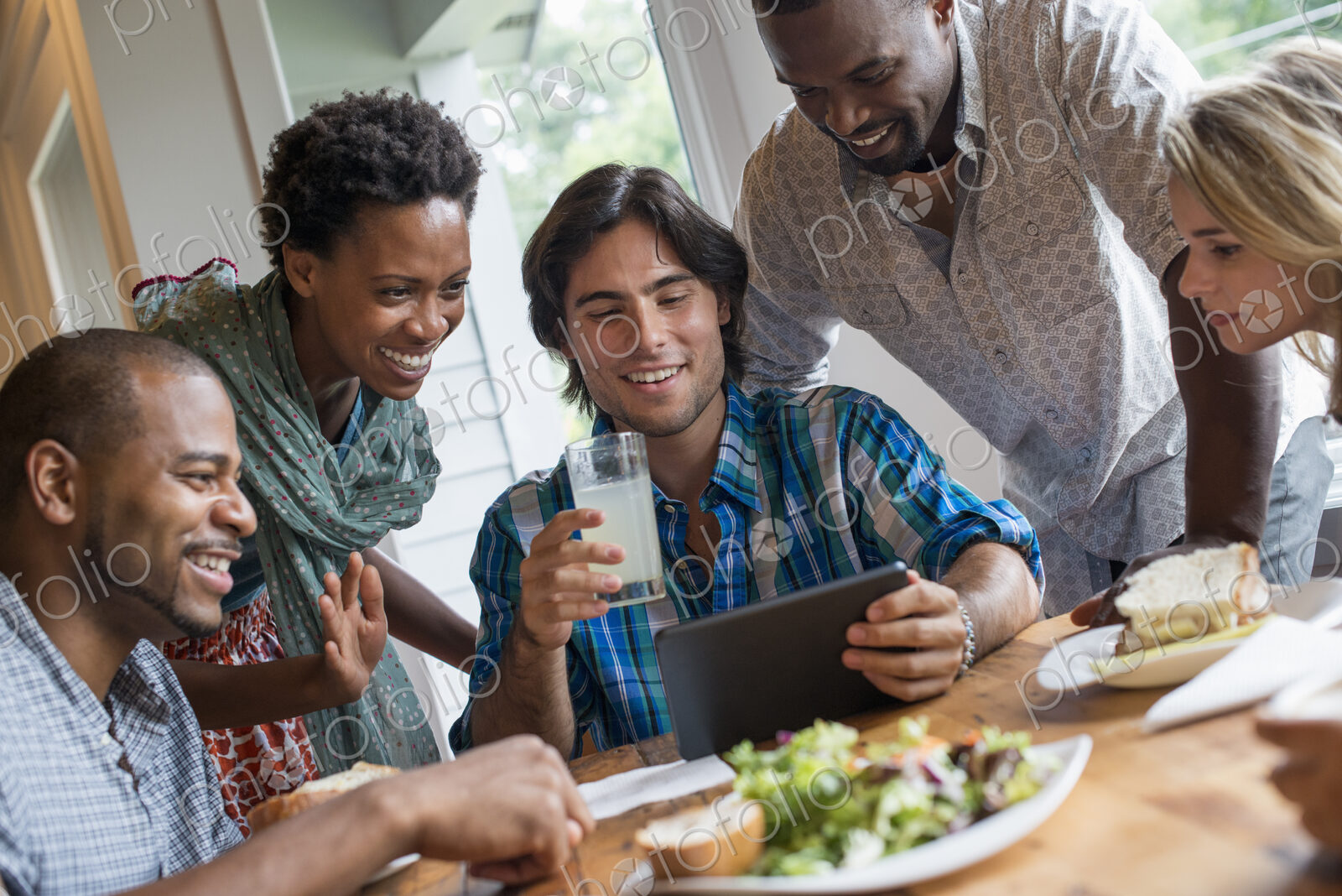 A group of people meeting in a cafe. Using digital tablets and smart phones.