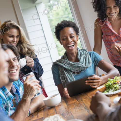 A group of people meeting in a cafe. Using digital tablets and smart phones. Having a… A group of people meeting in a cafe. Using digital tablets and smart phones. Having a…