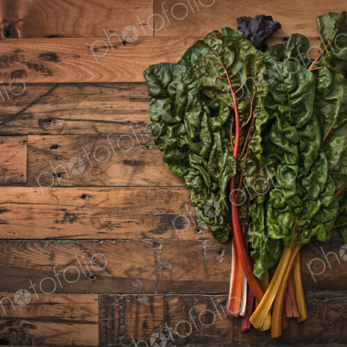 A group of red and orange chard leaves with bright coloured stems. Organic vegetables,… A group of red and orange chard leaves with bright coloured stems. Organic vegetables,…