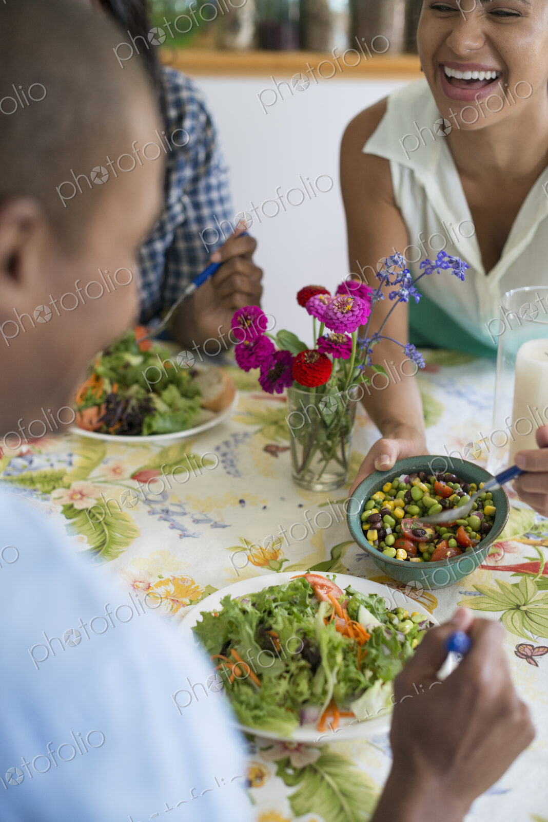 A group of women and men at a meal in a farmhouse kitchen.